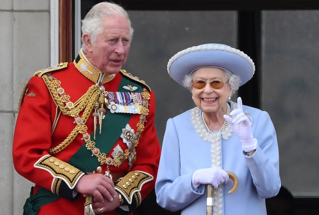 (FILES) In this file photo taken on June 2, 2022 Britain's Queen Elizabeth II (R) stands with Britain's Prince Charles, Prince of Wales to watch a special flypast from Buckingham Palace balcony following the Queen's Birthday Parade, the Trooping the Colour, as part of Queen Elizabeth II's platinum jubilee celebrations, in London. - The coronation ceremony of Britain's King Charles III and his wife, Britain's Camilla, Queen Consort, as King and Queen of the United Kingdom and Commonwealth Realm nations is scheduled to take place at Westminster Abbey, in London, on May 6, 2023. (Photo by Daniel LEAL / AFP) (Photo by DANIEL LEAL/AFP via Getty Images)